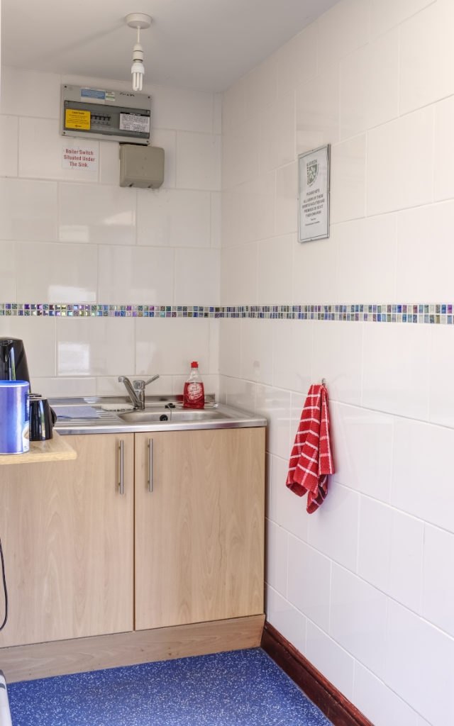 The changing room has a small kitchen area with sink and hot drinks facilities