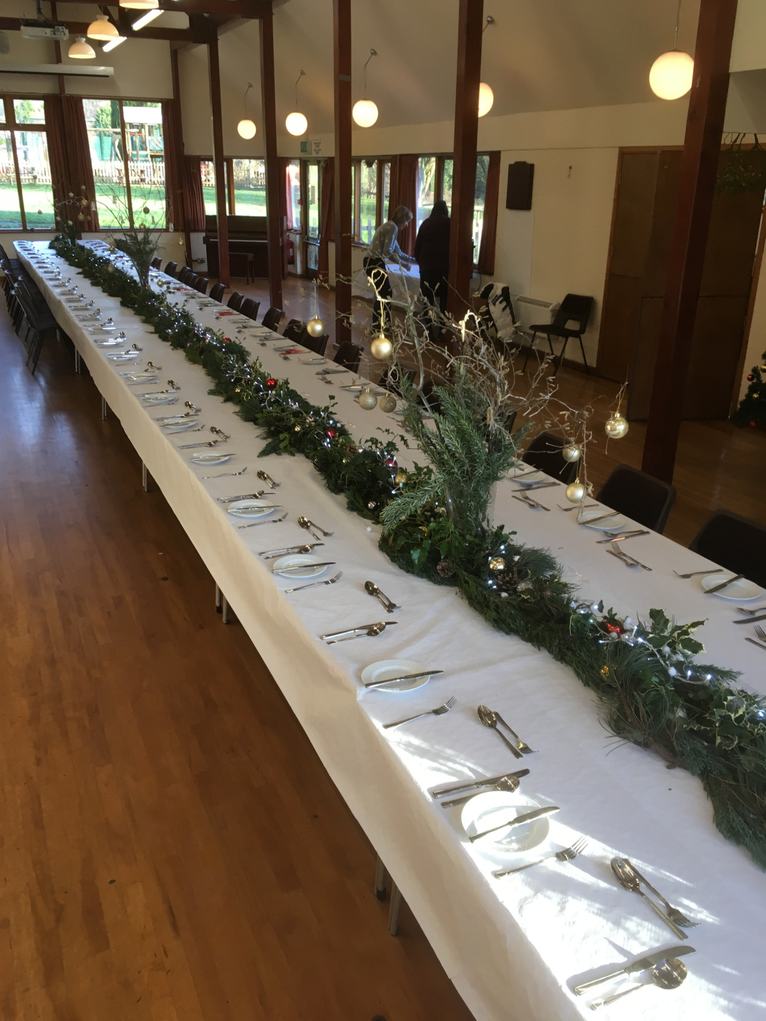 Several tables set up and dressed for the Christmas Meal