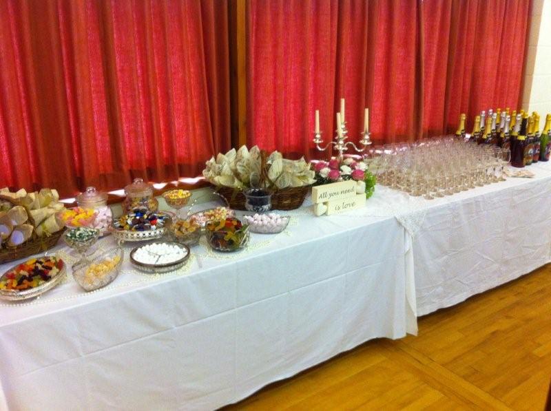 Tables decorated and loaded with food for a wedding