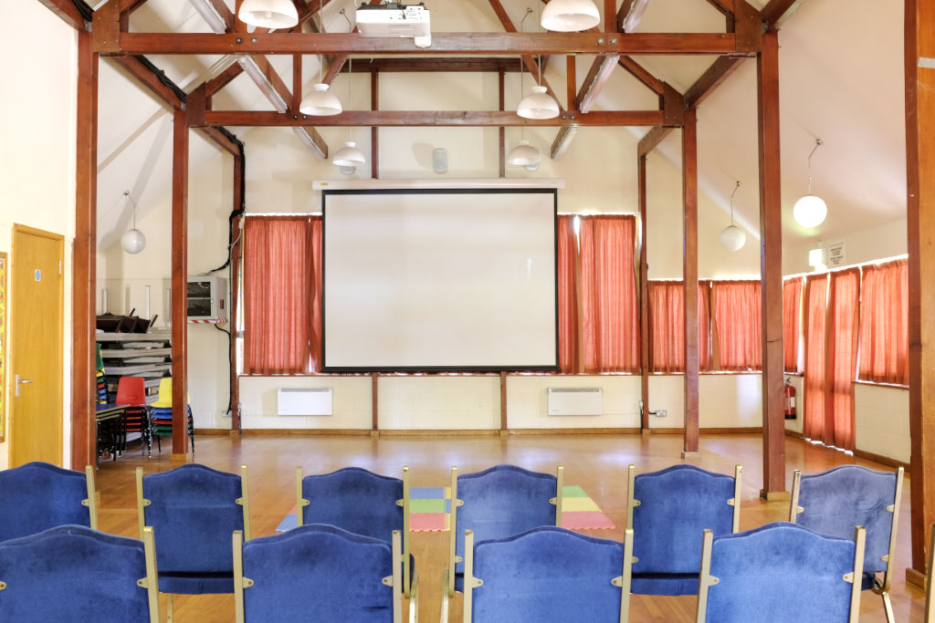 Hall interior with theatre seating and projector screen